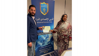 Businesswoman  Mrs. Awadiya Abdel-Hadi receives the certificate of participation and appreciation from the President of the Lobby, Dr. Ali El Masri for her participation in the Izmir Clothing Fair